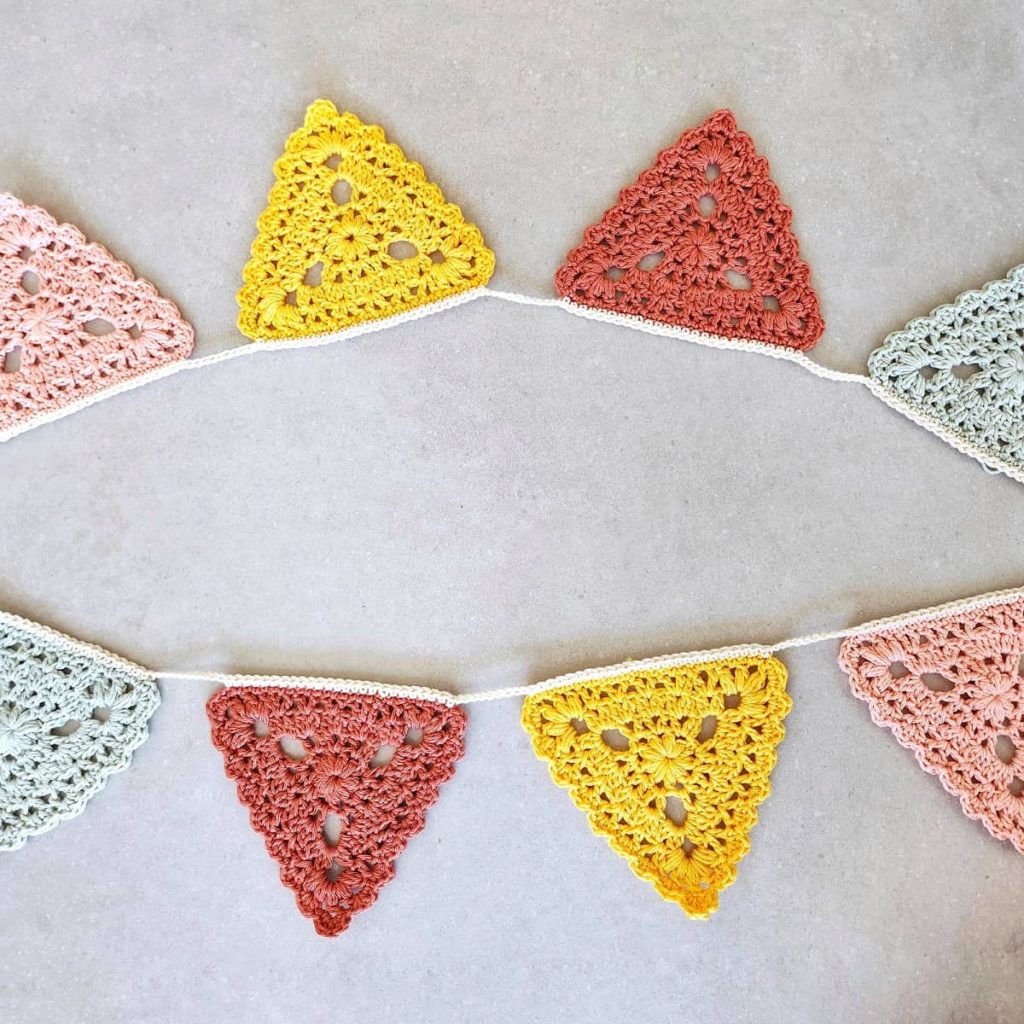 this is a photo of floral triangle bunting crochet pattern made by gootie
